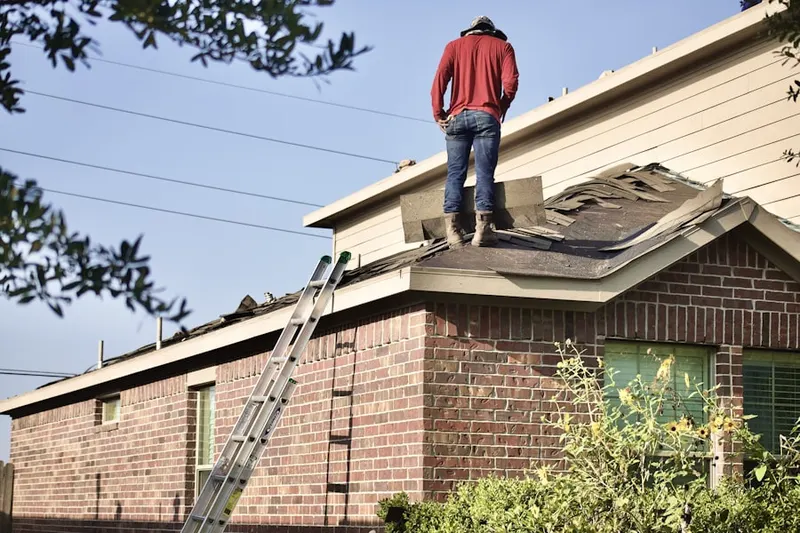 Professional roofer working on a residential roof in West Avenue
